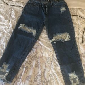 A pair of medium blue wash boyfriend jeans